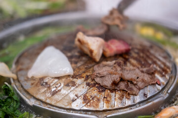 Thai style pork, bacon and seafood barbecue with vegetable soup