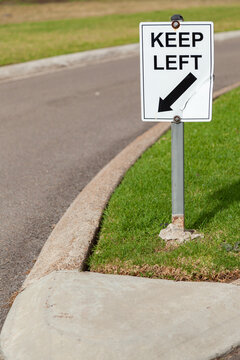Keep left sign beside road