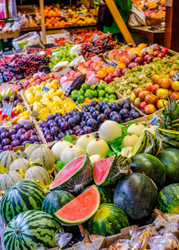 Vibrant collection of fresh fruits and vegetables displayed at a bustling market in summer