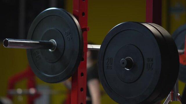 Rack for placing weight plates in a gym. Dumbbels weignts in gim. Exercise discs and barbells hang on racks in a gym