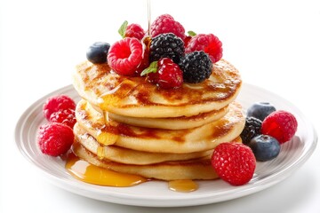 Delicious Stack of Fluffy Pancakes Topped with Fresh Berries and Maple Syrup on a White Plate for a Gourmet Breakfast Experience