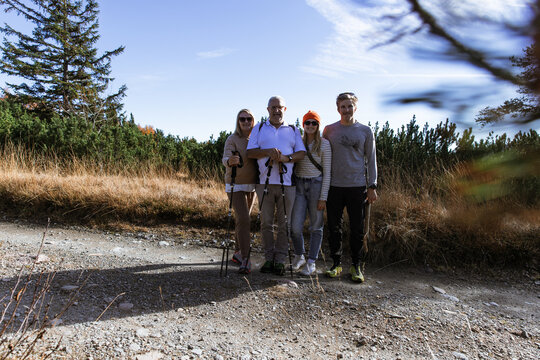 Group of hikers posing on a forest trail in South Tyrol