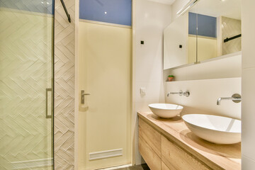 A contemporary bathroom featuring elegant fixtures, a stylish sink, and sleek storage, offering a perfect blend of functionality and aesthetics.