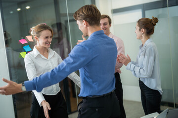 Fototapeta premium Team members celebrate achievements in a modern office environment during a collaborative session in the afternoon