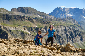Fototapeta premium Active mother and son trekking in mountains