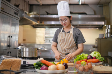 A female chef broadcasts her cooking knowledge live on a social media app on her mobile phone.