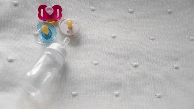 Bottle with baby pacifier close-up on a white background
