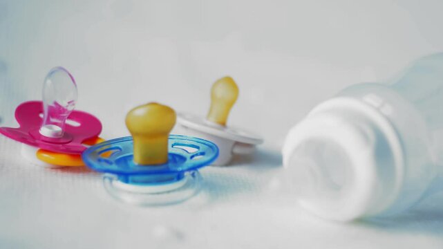 Bottle with baby pacifier close-up on a white background