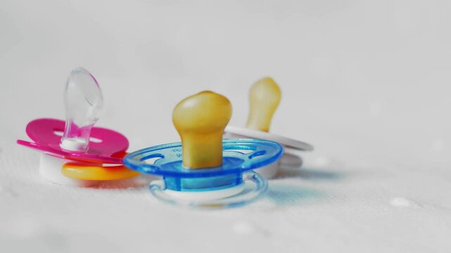 Bottle with baby pacifier close-up on a white background