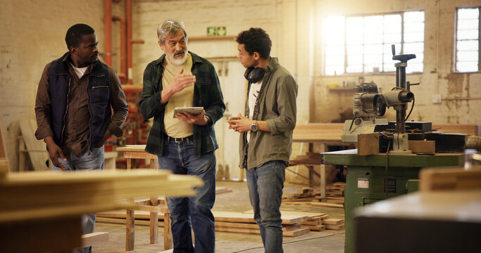 Workshop, online and group with tablet, carpenter and intern with research for woodworking technique. People, mature mentor and review of info on tech, trainee or collaboration for furniture business