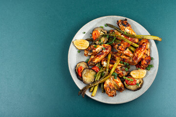 Baked chicken wings with asparagus and eggplant.