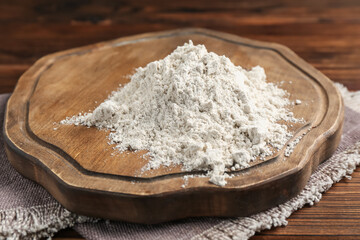 Pile of flour on wooden table, closeup