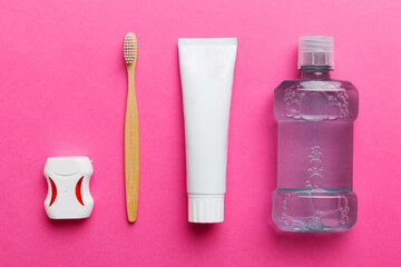 Mouthwash and other oral hygiene products on colored table top view with copy space. Flat lay....