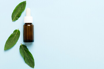 Natural Mint Essential Oil in a Glass Bottle. organic cosmetics with herbal extracts of mint on...