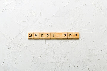 sanction word written on wood block. sanction text on table, concept