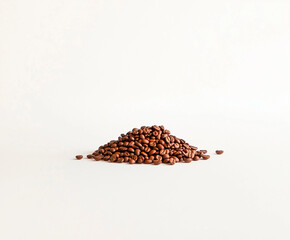 photo of a small pile of coffee beans on a white background