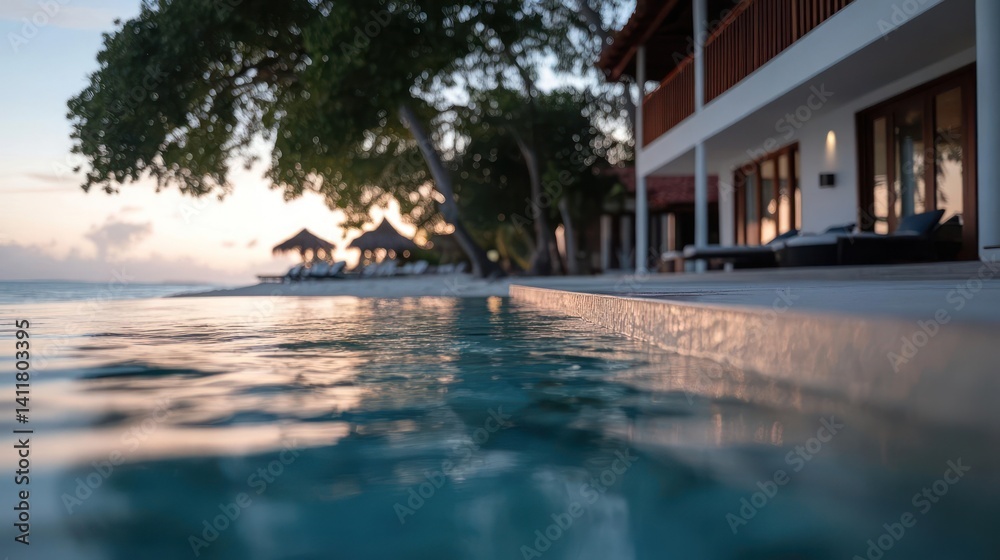 Poster a tranquil view of turquoise water from an infinity pool, leading to a sandy beach with palm trees u