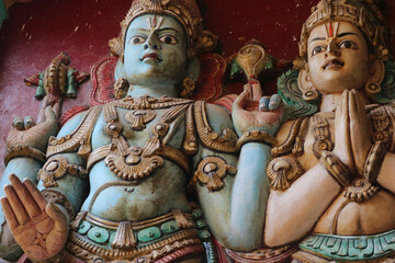 Ancient Sculptural Representations of Lord Vishnu and Goddess Lakshmi Bestowing Blessings in a South Indian Temple: A Symbol of Prosperity and Divine Protection
