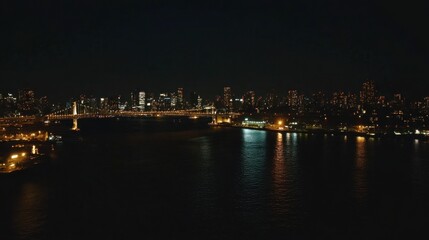 Fototapeta premium Elevated view of Rainbow Bridge lit up against the Tokyo Bay skyline, no human activity.