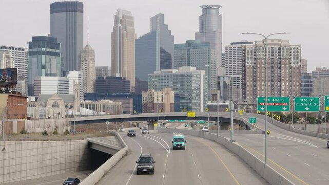 Cars Driving On Freeway With Minneapolis Skyline In Background, Minnesota, USA - Wide Shot