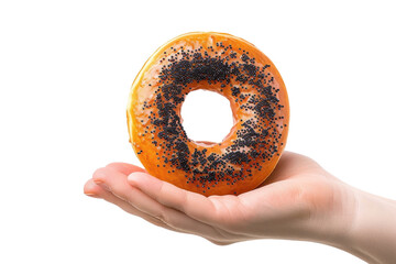 A hand delicately holds a unique donut topped with poppy seeds, showcasing its vibrant orange glaze against a stark white background isolated on transparent background