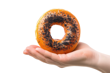 A hand delicately holds a unique donut topped with poppy seeds, showcasing its vibrant orange glaze against a stark white background isolated on transparent background