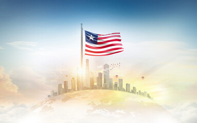 Liberia national flag with mast waving in beautiful sky. Liberia flag for Republic Day and Independence Day.