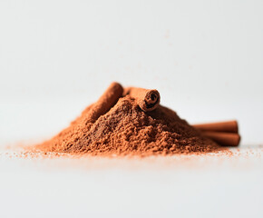 photo of a small mound of .cinnamon on a white background