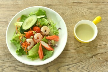 boiled shrimp and crab stick with vegetable seafood salad on plate dressing cream sauce