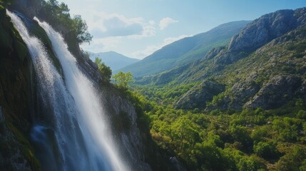 Fototapeta premium A majestic waterfall cascading down a rugged mountain landscape beautifully