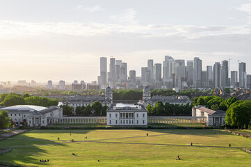 View of the modern buildings of Canary Wharf, over the old Royal Naval Acadamy of Greenwhich, on a summers evening in London