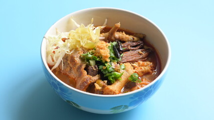 rice vermicelli with northern thai curry sauce on blue background