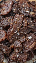 Obraz premium Dark savory jerky boasts rich brown tones subtly sprinkled with salt. AI Generated