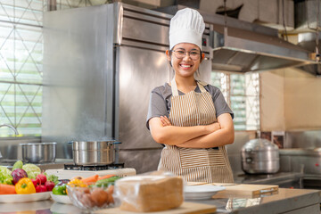 Smiling Female Chef in Kitchen with Fresh Vegetables on Counter