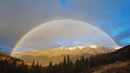 Naklejka premium Rainbow over the mountains
