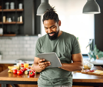 kitchen man food cooking preparation ingredient laptop recipe internet tablet guy computer happy preparing eating home business work office businessman breakfast online social media app using