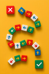 Playful Decision-Making and Strategic Choices Concept with Colorful Dice Path, Arrows, Wrong Turn Symbol and Checkmark, Representing Exploration, Risk, and Smart Navigation on Bright Yellow Background