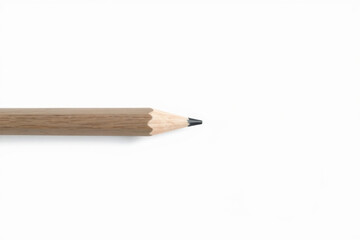 Minimalist composition of a sharpened gray pencil on a clean white background, representing simplicity, creativity, and stationery essentials. Copy space