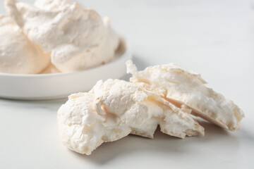 Delicious homemade meringue cookies on light table, closeup