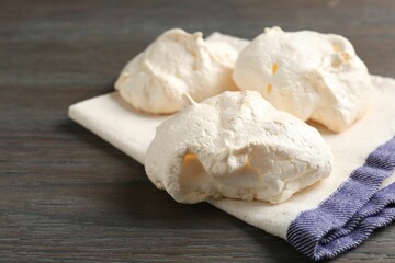 Delicious homemade meringue cookies on wooden table, closeup