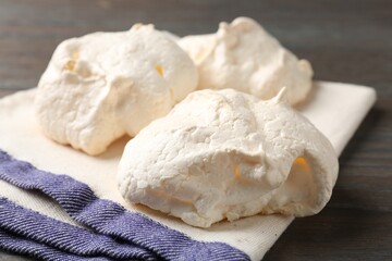 Delicious homemade meringue cookies on wooden table, closeup