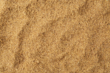 Superfood. Coriander powder as background, top view