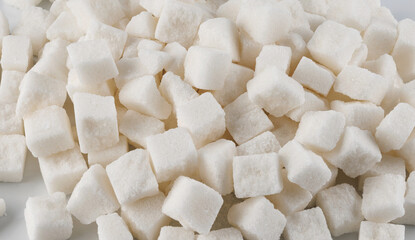 Background of pieces of crushed white sugar. White sugar.