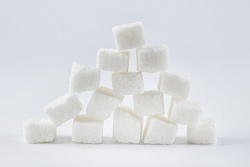 Pieces of white crushed sugar on a white background. White on white.