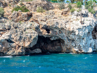 Grotto and coastal cliffs. The blue Mediterranean Sea. Antalya, Turkey