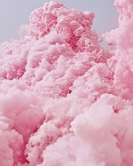 A fluffy pink cloud of smoke billows gracefully against a clear blue sky, creating a dreamy and whimsical atmosphere. The soft hues blend beautifully, evoking a sense of calm and wonder.