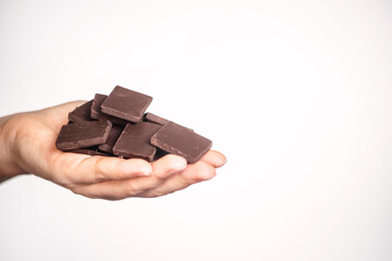 slices of delicious dark chocolate on a light background.