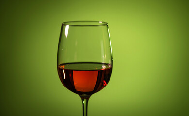 glass of pink wine on a colored background.
