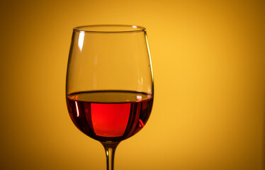 glass of pink wine on a colored background.