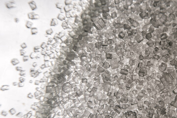 White sugar crystals in macro – detailed close-up of crystalline structure used in food,...